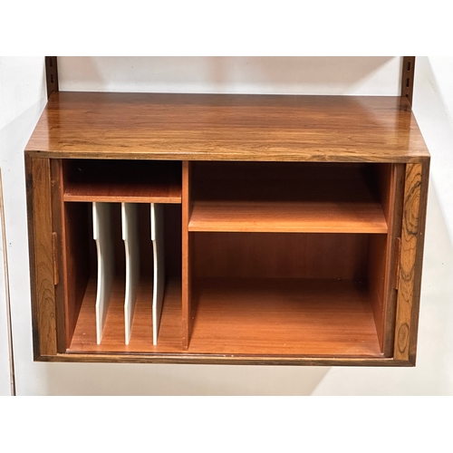 12A - Kai Kristensen. A Danish Mid Century rosewood wall modular shelving system. Designed by Kai Kristens... 