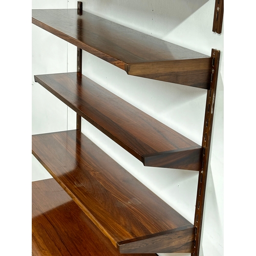 12A - Kai Kristensen. A Danish Mid Century rosewood wall modular shelving system. Designed by Kai Kristens... 