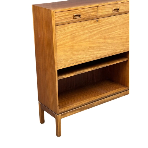 112 - A 1970’s Mid Century teak cocktail cabinet/work station. By Mann Egerton. 137.5x35.5x123cm.