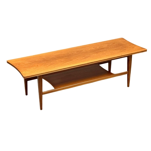 520B - Richard Hornby. A Mid Century teak surfboard coffee table. Designed by Richard Hornby for Fyne Ladye... 