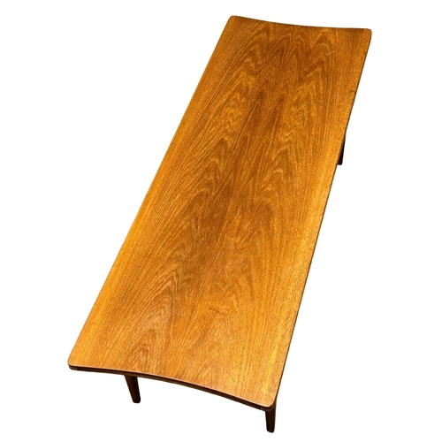 520B - Richard Hornby. A Mid Century teak surfboard coffee table. Designed by Richard Hornby for Fyne Ladye... 