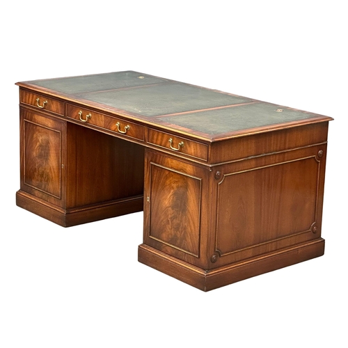 73 - A large Georgian style mahogany pedestal writing desk with leather top. 167.5x87x76cm.(4)