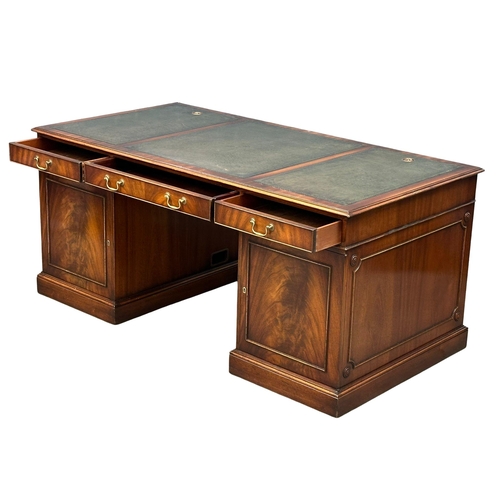 73 - A large Georgian style mahogany pedestal writing desk with leather top. 167.5x87x76cm.(4)