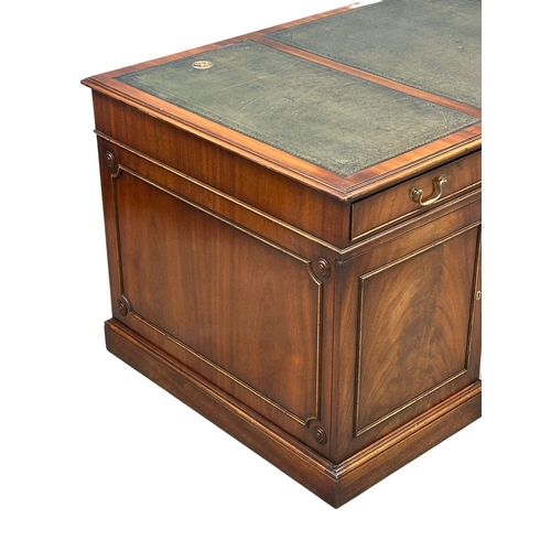 73 - A large Georgian style mahogany pedestal writing desk with leather top. 167.5x87x76cm.(4)