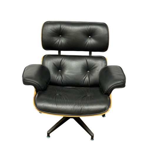 10 - A Charles & Ray Eames style leather swivel armchair and ottoman.