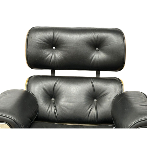 10 - A Charles & Ray Eames style leather swivel armchair and ottoman.