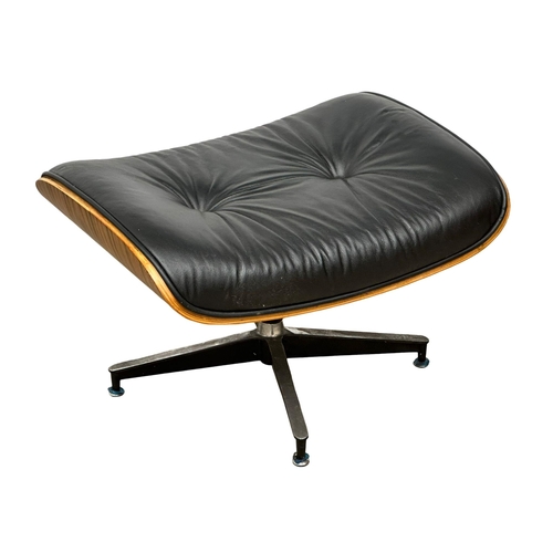 10 - A Charles & Ray Eames style leather swivel armchair and ottoman.