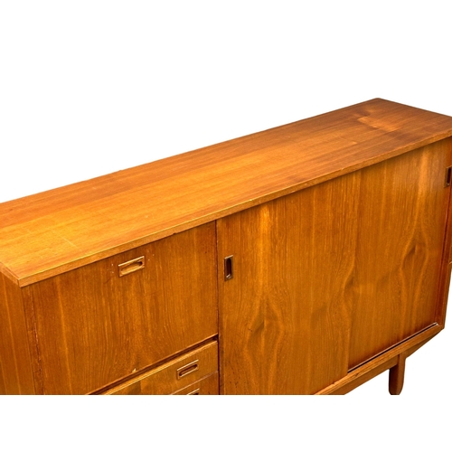 146 - A Mid Century teak cocktail sideboard. 183x46x114.5cm(5)