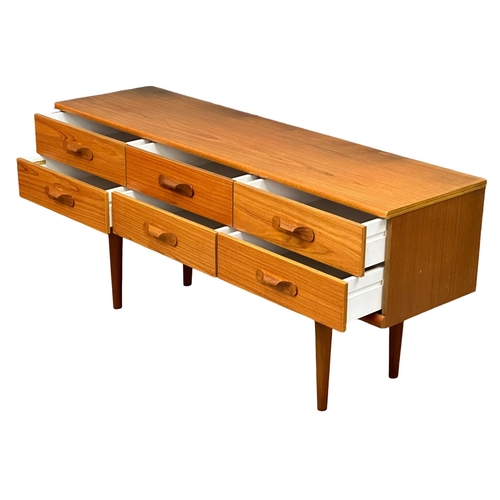 189 - Frank Guille. A Mid Century teak sideboard. Designed by Frank Guille for Austinsuite. 152x43x70cm