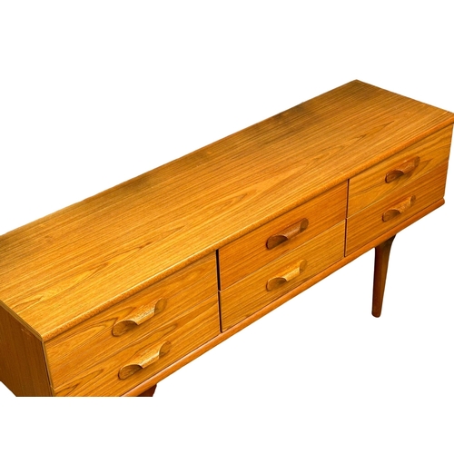 189 - Frank Guille. A Mid Century teak sideboard. Designed by Frank Guille for Austinsuite. 152x43x70cm