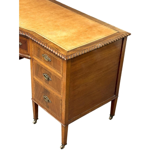 195 - A large Early 20th Century Sheraton Revival inlaid mahogany writing desk with leather top. Circa 190... 