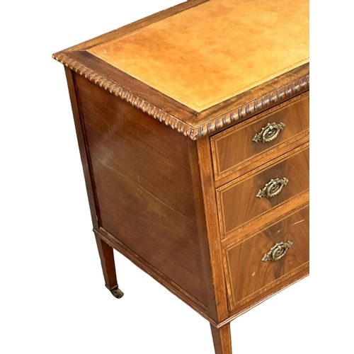 195 - A large Early 20th Century Sheraton Revival inlaid mahogany writing desk with leather top. Circa 190... 