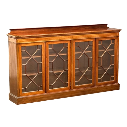 21 - A large good quality Early 20th Century Sheraton Revival inlaid mahogany bookcase, with astragal gla... 