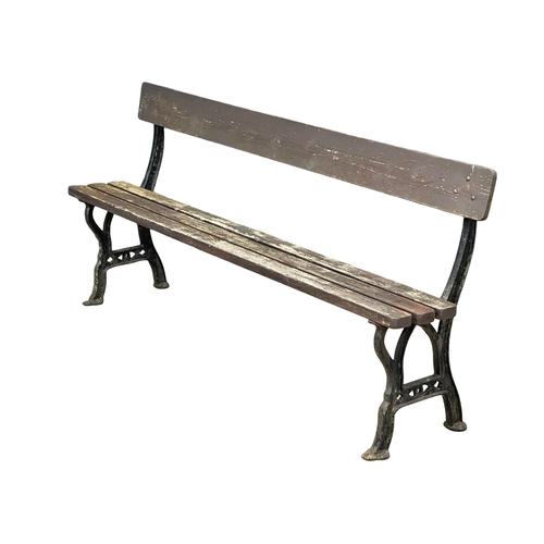 413 - A Late Victorian cast iron garden bench with wooden straps. 183cm. (5)