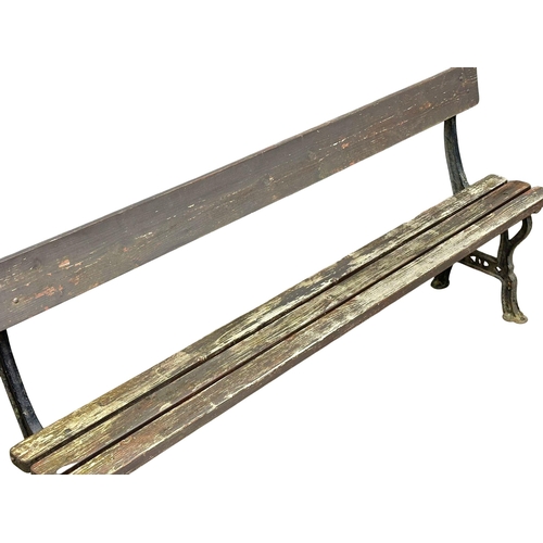 413 - A Late Victorian cast iron garden bench with wooden straps. 183cm. (5)