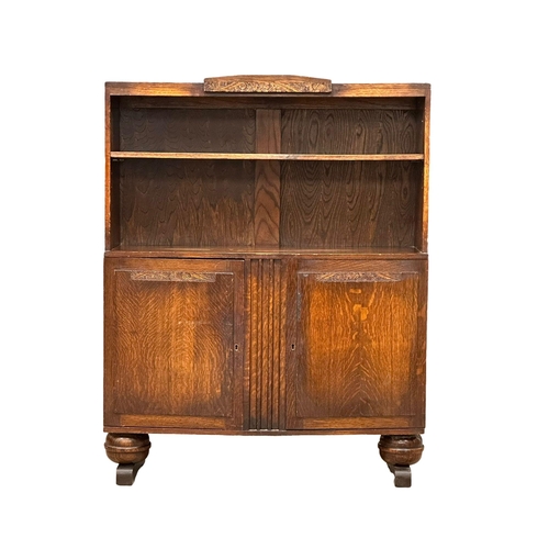 423 - A 1930’s Art Deco oak open bookcase. 92x27x117cm (5)