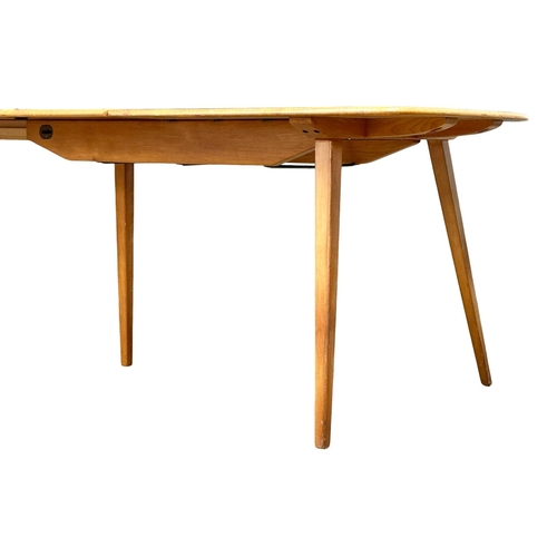 44 - A rare Ercol Mid Century elm and beech extending dining table. Model 444. Open 225x84x71cm. Closed 1... 