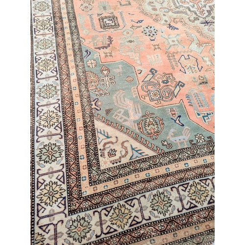 443 - A very large Persian hand knotted rug. 380x292cm