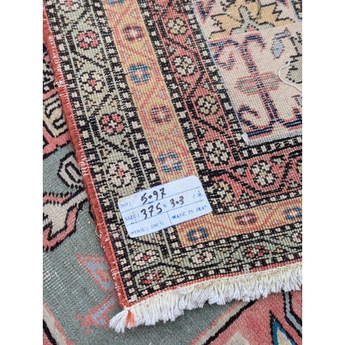 443 - A very large Persian hand knotted rug. 380x292cm