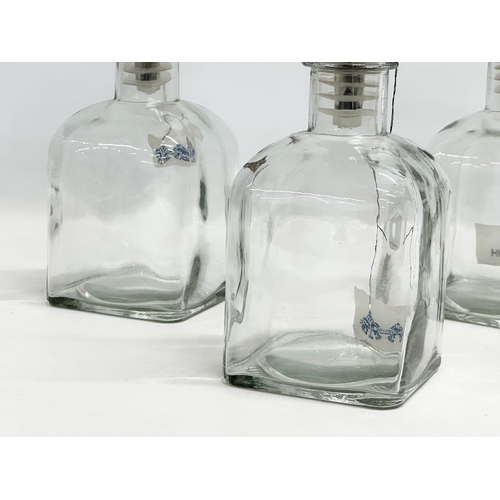 502 - A set of 4 novelty Giraffe and Rhino head glass decanters. 25cm