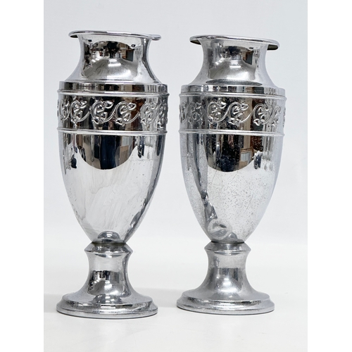 516 - A pair of Early 20th Century silver plated vases. 21cm