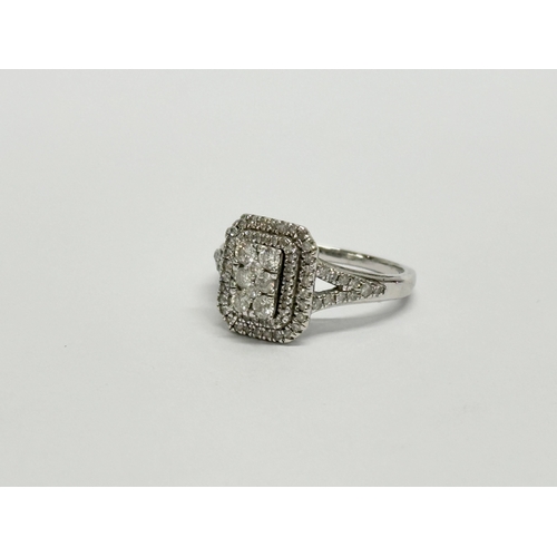 615 - A 9ct white gold & 0.5ct diamond ring. Size K, 3 gram total.    (8)