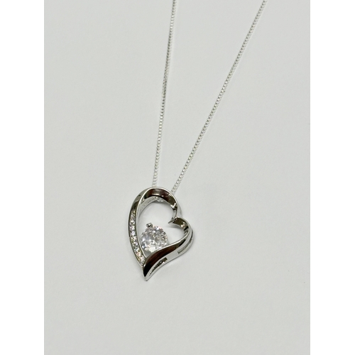 616 - A Sterling silver heart necklace with cubic zirconia.    (8)