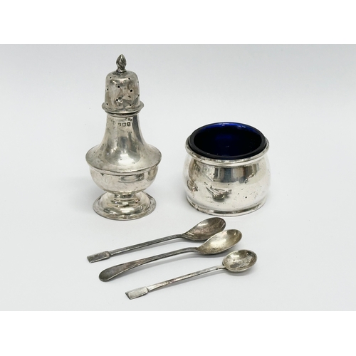 626 - A collection of silver. A William Aitken silver pepper shaker, Birmingham 1910. A D&S silver salt wi... 