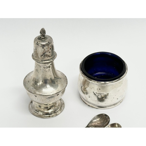 626 - A collection of silver. A William Aitken silver pepper shaker, Birmingham 1910. A D&S silver salt wi... 