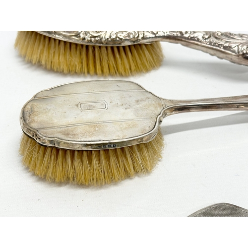 629 - 2 silver backed brushes and a vanity mirror.