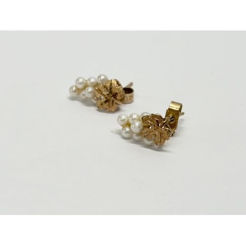 630 - A pair of 9ct gold and pearl earrings.