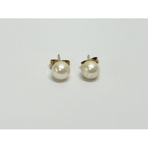 631 - A pair of 9ct gold and pearl earrings.  (10)