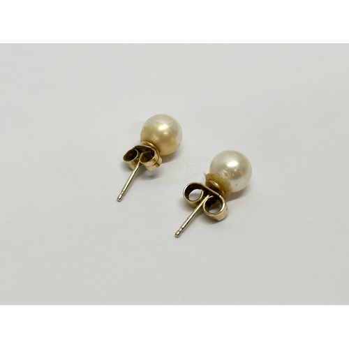 631 - A pair of 9ct gold and pearl earrings.  (10)