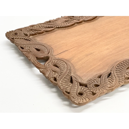 523 - An Early 20th Century Chinese carved teak tray. 59x36cm