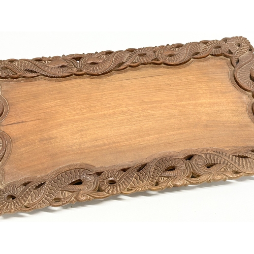 523 - An Early 20th Century Chinese carved teak tray. 59x36cm