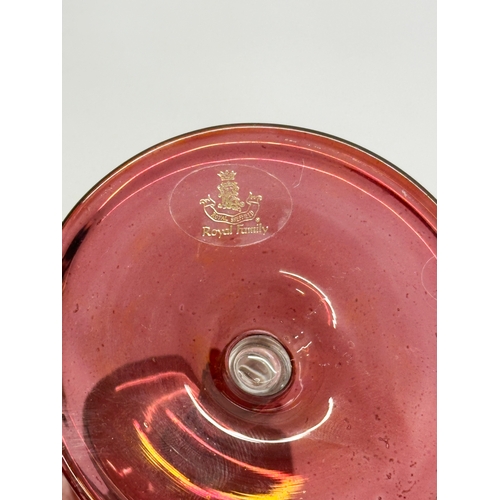 713 - Royal Sheffield Collection. A pair of gilt ruby “Royal Family” wine glasses. 20cm