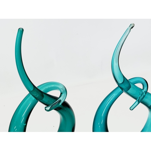 534 - A pair of art glass swirling sculptures. 17x32cm.