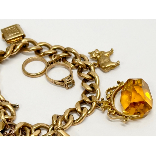 584 - A 9ct gold charm bracelet. 50 grams.  (3)