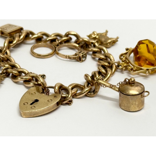 584 - A 9ct gold charm bracelet. 50 grams.  (3)