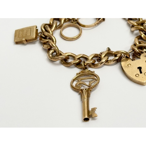 584 - A 9ct gold charm bracelet. 50 grams.  (3)