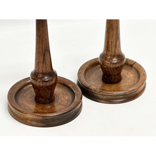 111 - A pair of tall Early 20th Century oak candlesticks. Circa 1910-1920. 33cm