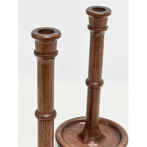 112 - A pair of vintage padauk candlesticks. 13x28cm