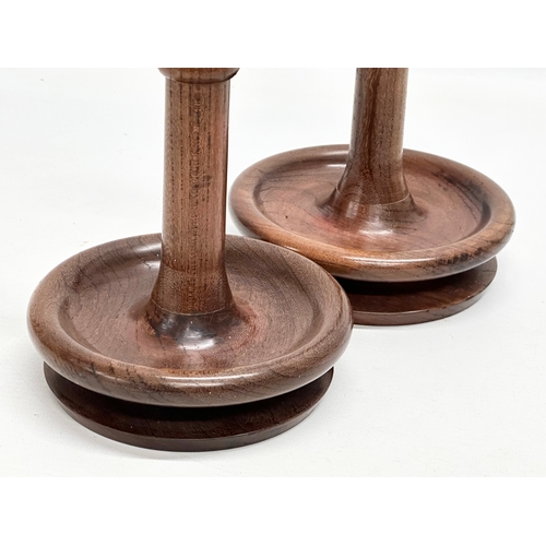 112 - A pair of vintage padauk candlesticks. 13x28cm