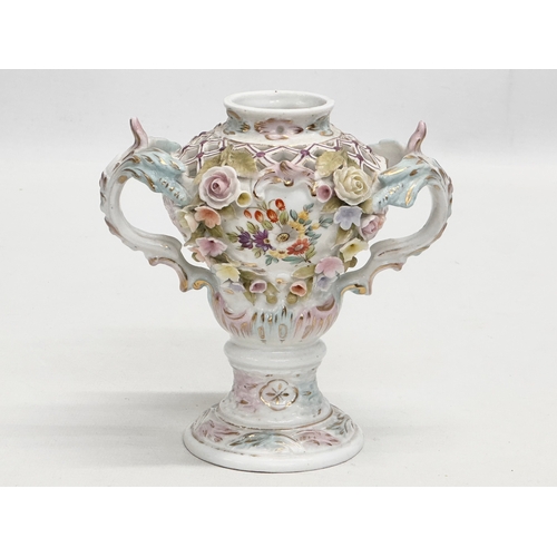 104 - Sitzendorf. A Late 19th Century hand painted and pierced porcelain urn shaped vase, with foliage flo... 