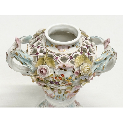 104 - Sitzendorf. A Late 19th Century hand painted and pierced porcelain urn shaped vase, with foliage flo... 