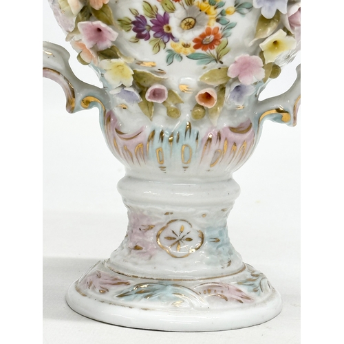 104 - Sitzendorf. A Late 19th Century hand painted and pierced porcelain urn shaped vase, with foliage flo... 