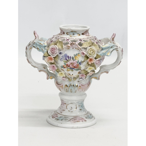 104 - Sitzendorf. A Late 19th Century hand painted and pierced porcelain urn shaped vase, with foliage flo... 