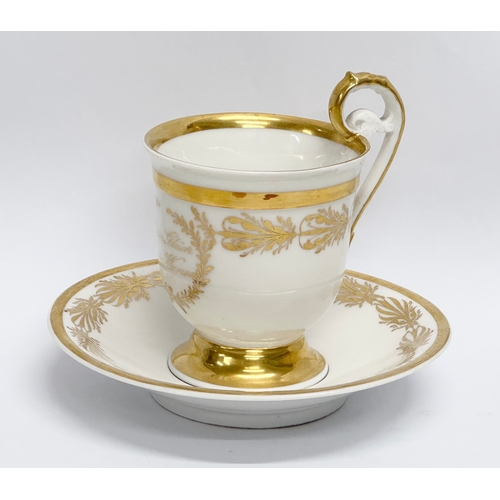 10 - KPM Berlin. An Early 19th Century gilt porcelain cup and saucer. Dein Gluck Mein Wunsch.