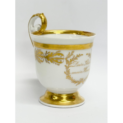 10 - KPM Berlin. An Early 19th Century gilt porcelain cup and saucer. Dein Gluck Mein Wunsch.