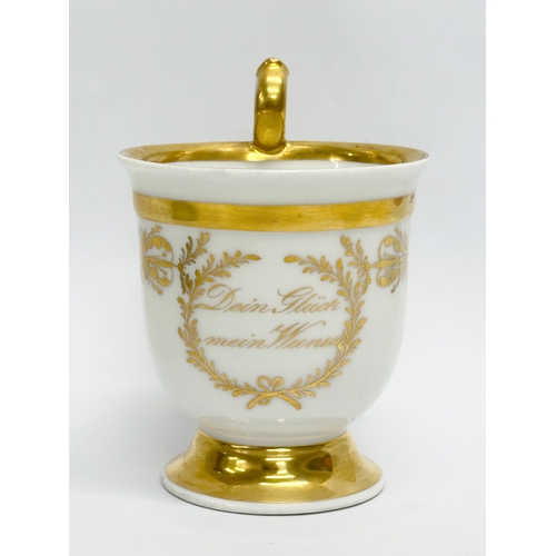 10 - KPM Berlin. An Early 19th Century gilt porcelain cup and saucer. Dein Gluck Mein Wunsch.